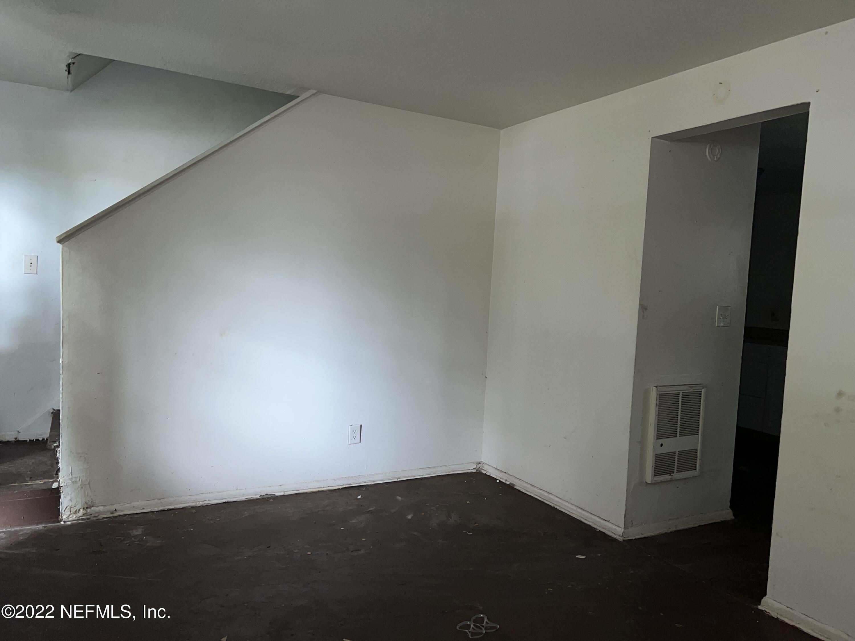 4423 Moncrief Road Jacksonville, FL 32209 - Photo 14 of 47 an empty room with wooden floor and closet