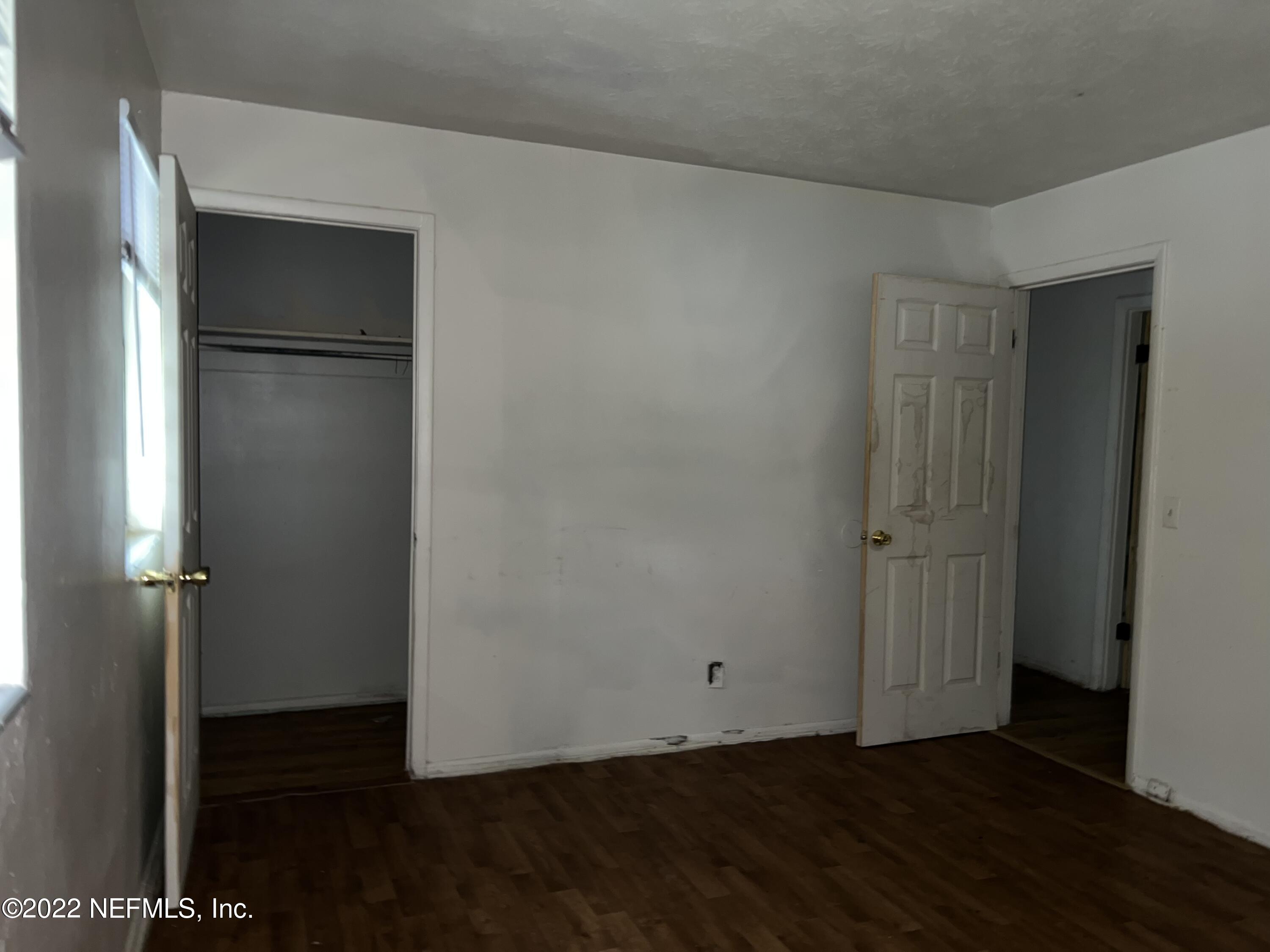 4423 Moncrief Road Jacksonville, FL 32209 - Photo 32 of 47 an empty room with wooden floor and closet