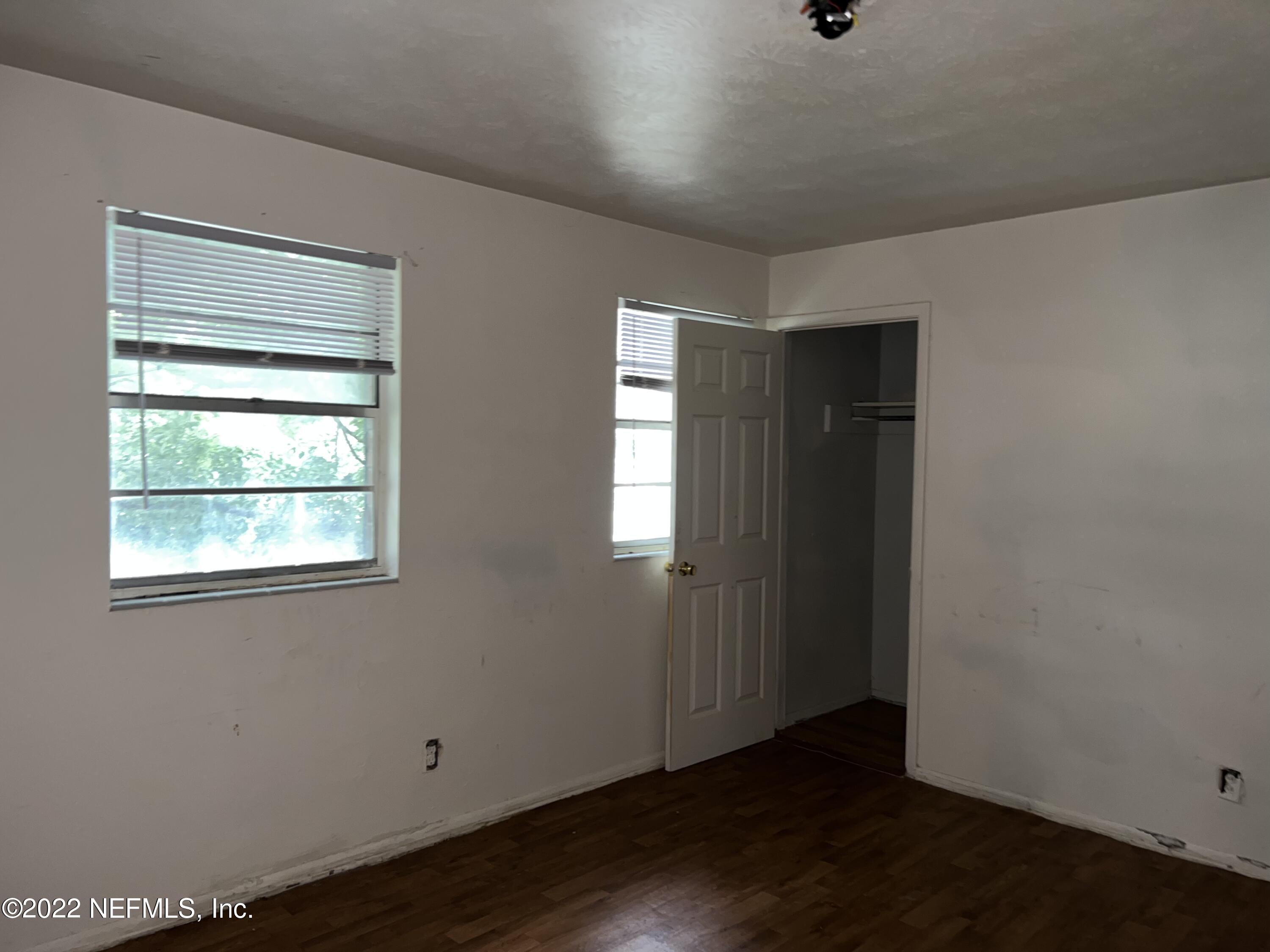 4423 Moncrief Road Jacksonville, FL 32209 - Photo 33 of 47 an empty room with wooden floor and windows