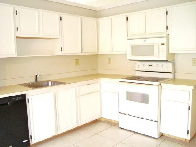 11460 Woodchuck Drive Boca Raton, FL 33428 - Photo 13 of 32 a kitchen with a sink stove and cabinets