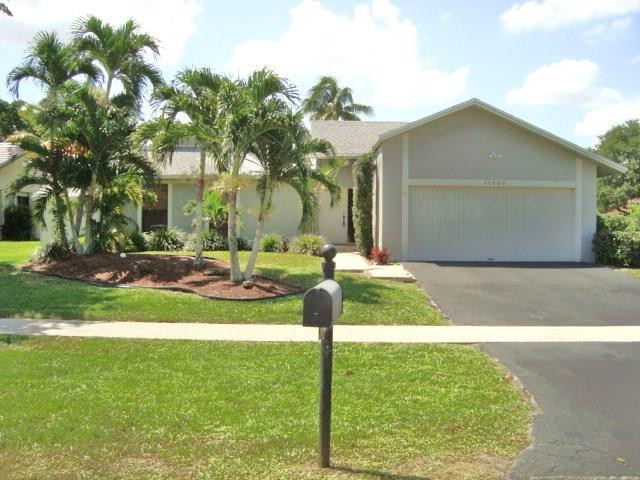 11460 Woodchuck Drive Boca Raton, FL 33428 - Photo 2 of 32 a front view of a house with garden