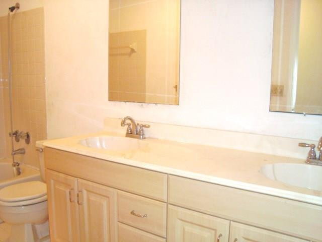 11460 Woodchuck Drive Boca Raton, FL 33428 - Photo 21 of 32 a bathroom with a sink and a toilet