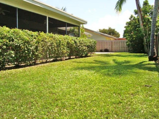11460 Woodchuck Drive Boca Raton, FL 33428 - Photo 26 of 32 a front view of a house with garden