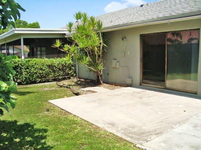 11460 Woodchuck Drive Boca Raton, FL 33428 - Photo 30 of 32 a front view of a house with a yard