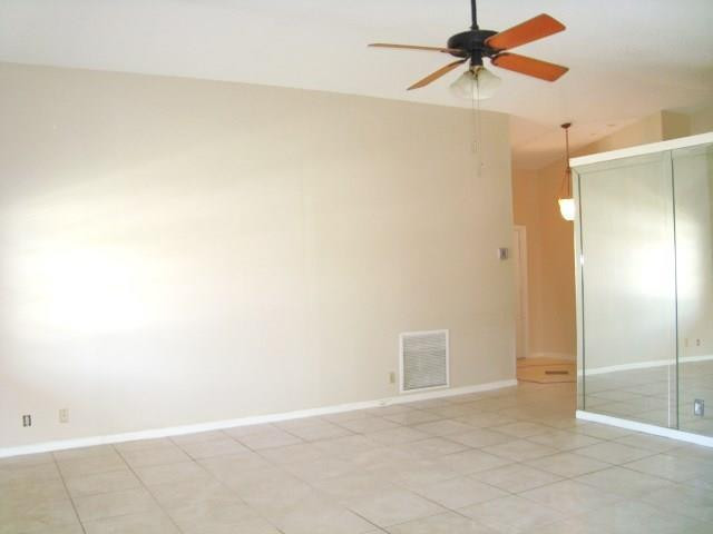 11460 Woodchuck Drive Boca Raton, FL 33428 - Photo 8 of 32 a view of a room with a ceiling fan and a shower