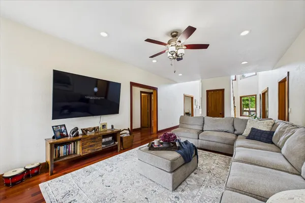 a view of a hallway with wooden floor and windows