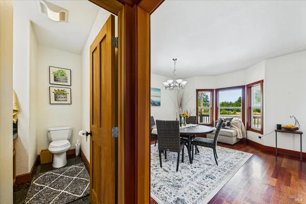 a view of an empty room with furniture wooden floor and window