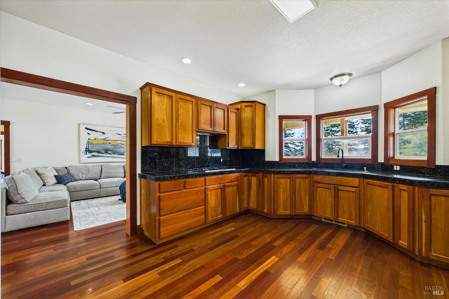 1150 Dinsmore Ranch Road Rio Dell, CA 95562 - Photo 27 of 71 a large living room with stainless steel appliances granite countertop wooden floors and a large window