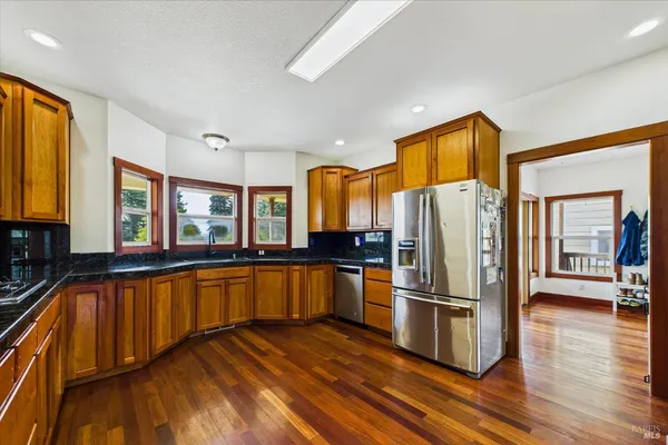 a bathroom with a granite countertop sink and a large mirror