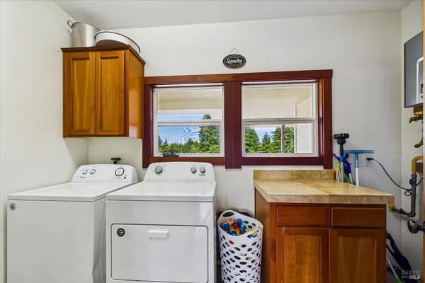 a view of a room with wooden floor and a potted plant
