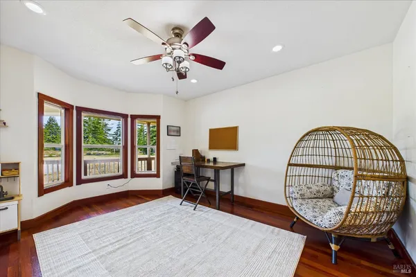 a view of a hallway with furniture and window