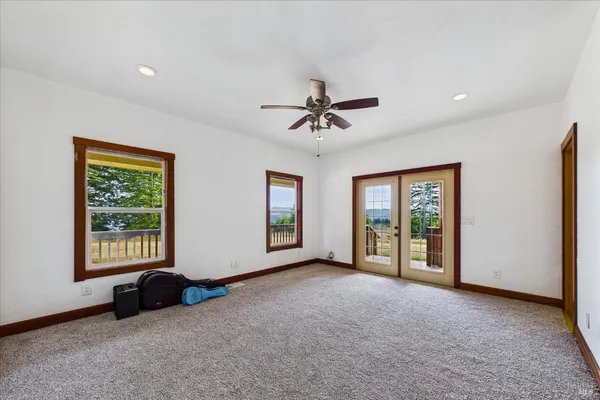 a bedroom with a bed and a mirror on dresser