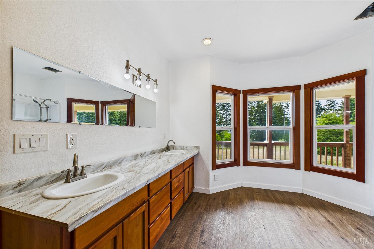 1150 Dinsmore Ranch Road Rio Dell, CA 95562 - Photo 42 of 71 a bathroom with a granite countertop sink and a large mirror