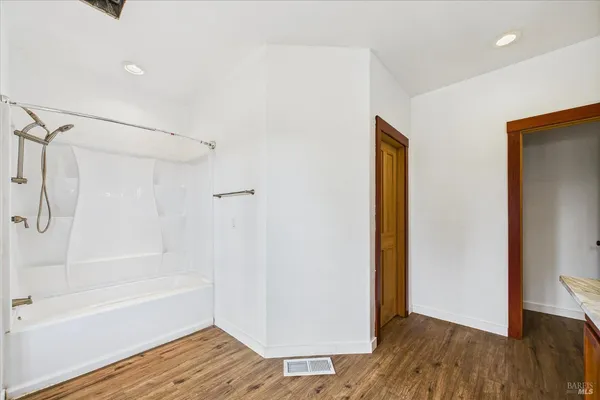 a bathroom with a toilet and a shower curtain
