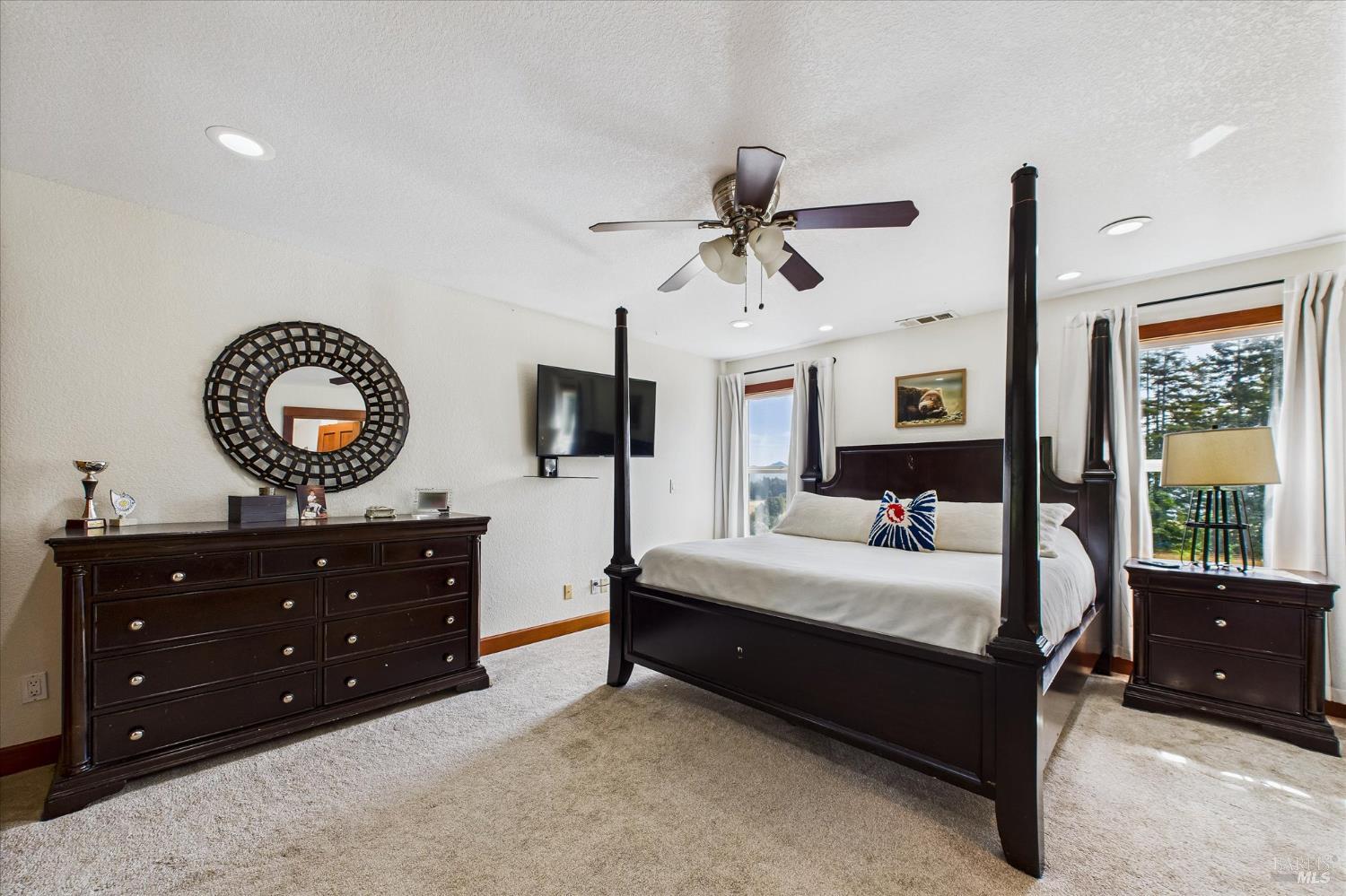 1150 Dinsmore Ranch Road Rio Dell, CA 95562 - Photo 50 of 71 a bedroom with a bed and a mirror on dresser