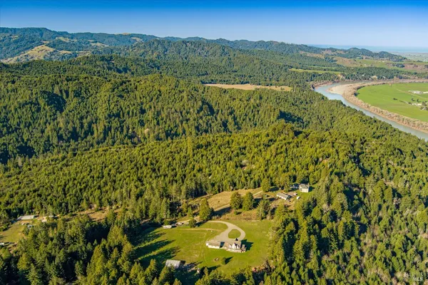 a front view of a house with a yard table and chairs