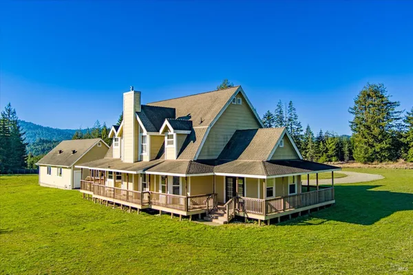 a view of a house with a yard balcony and sitting area