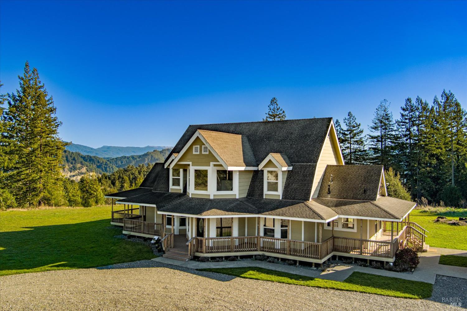 1150 Dinsmore Ranch Road Rio Dell, CA 95562 - Photo 8 of 71 a view of a big house with a big yard and large trees