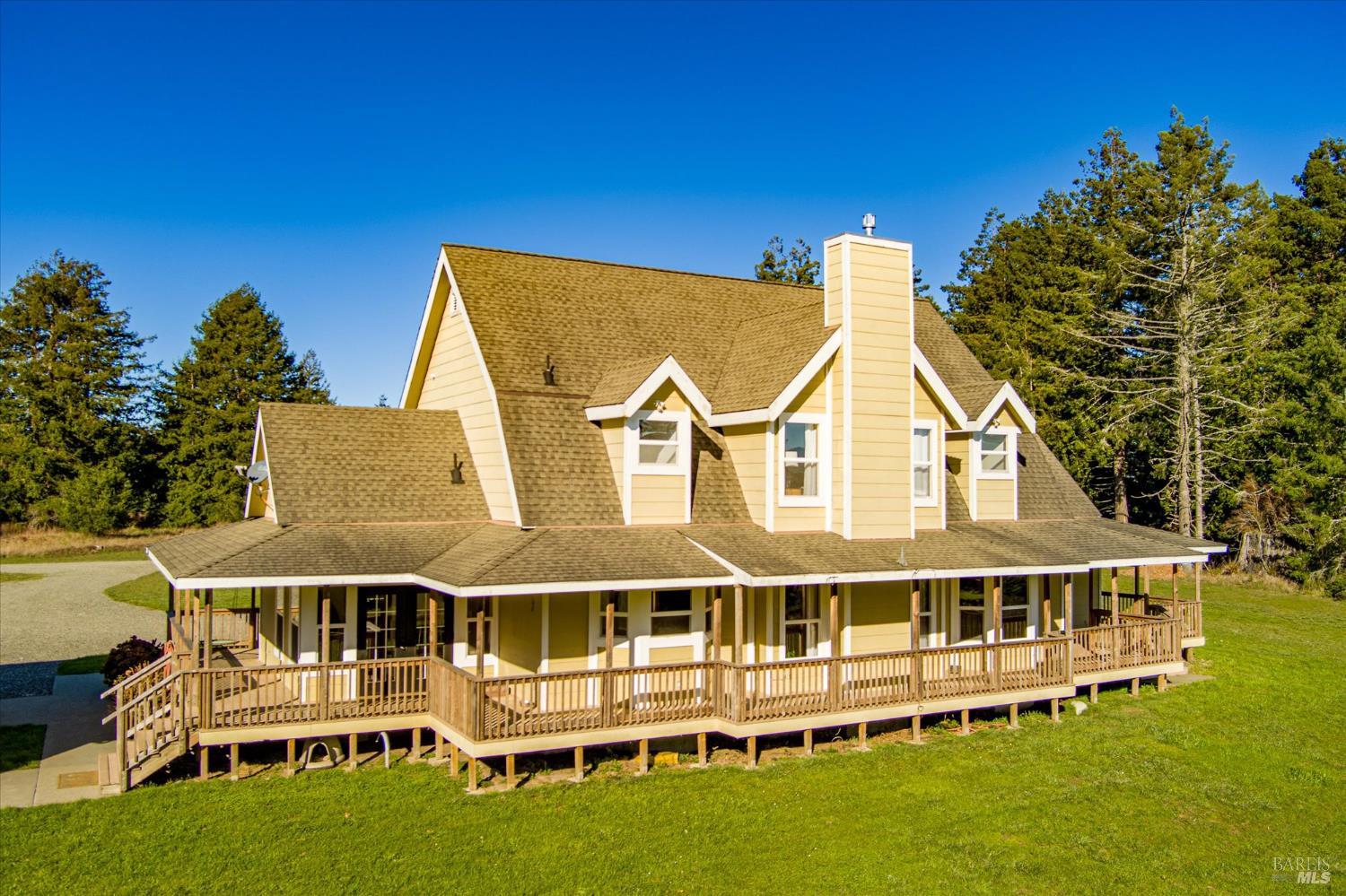 1150 Dinsmore Ranch Road Rio Dell, CA 95562 - Photo 10 of 71 a view of a large building with a big yard and large trees