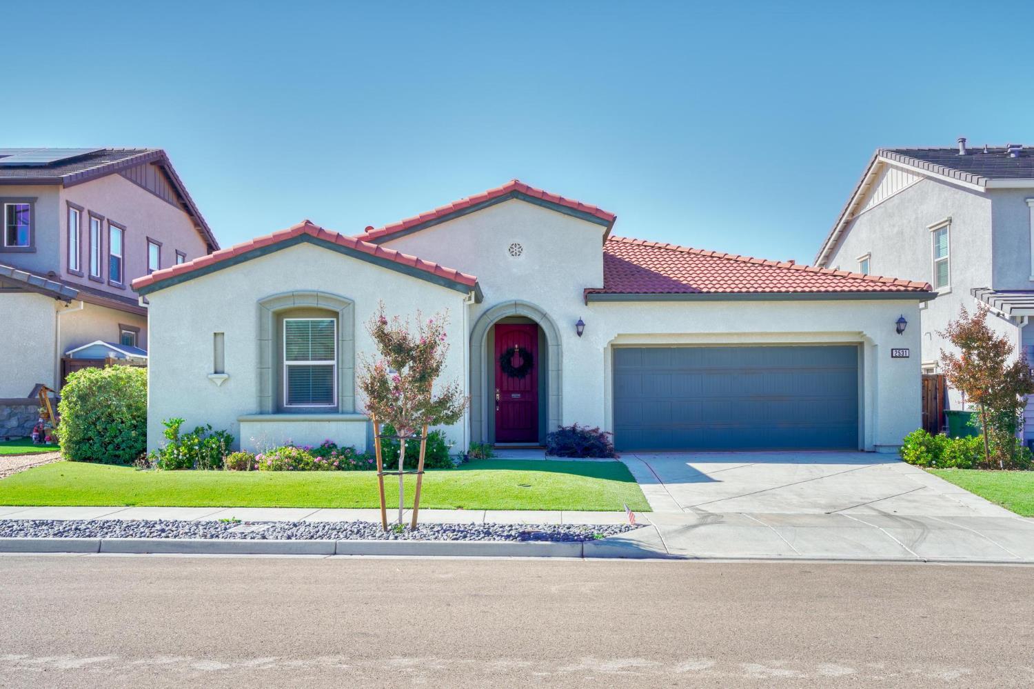 a view of a house with a yard and garage