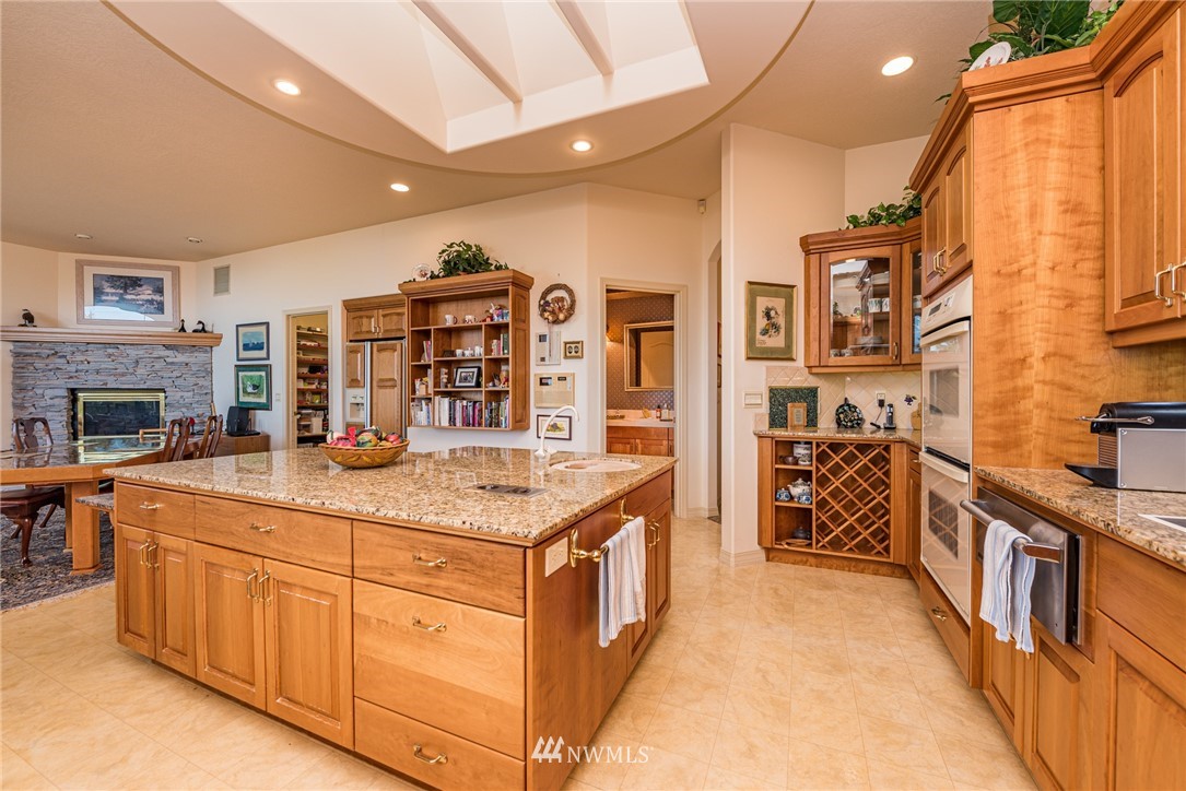 53 Quails Roost Road Sequim, WA 98382 - Photo 15 of 40 a kitchen with stainless steel appliances granite countertop a stove and cabinets