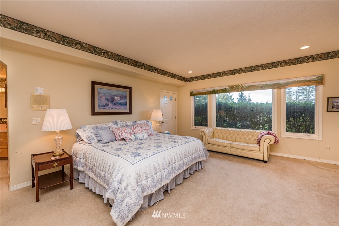 53 Quails Roost Road Sequim, WA 98382 - Photo 30 of 40 a bedroom with a bed and a large window
