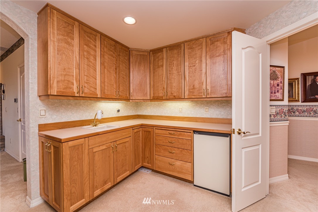 53 Quails Roost Road Sequim, WA 98382 - Photo 31 of 40 a kitchen with stainless steel appliances granite countertop a sink stove and cabinets