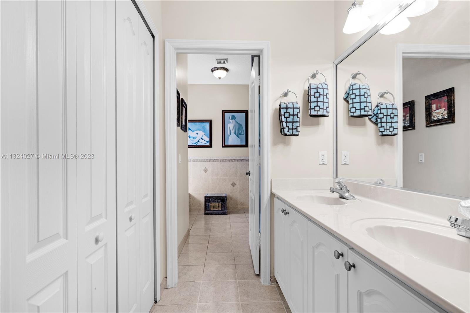 16056 Southwest 66th Terrace Miami, FL 33193 - Photo 11 of 24 a en suite bathroom with a double vanity sink and a mirror