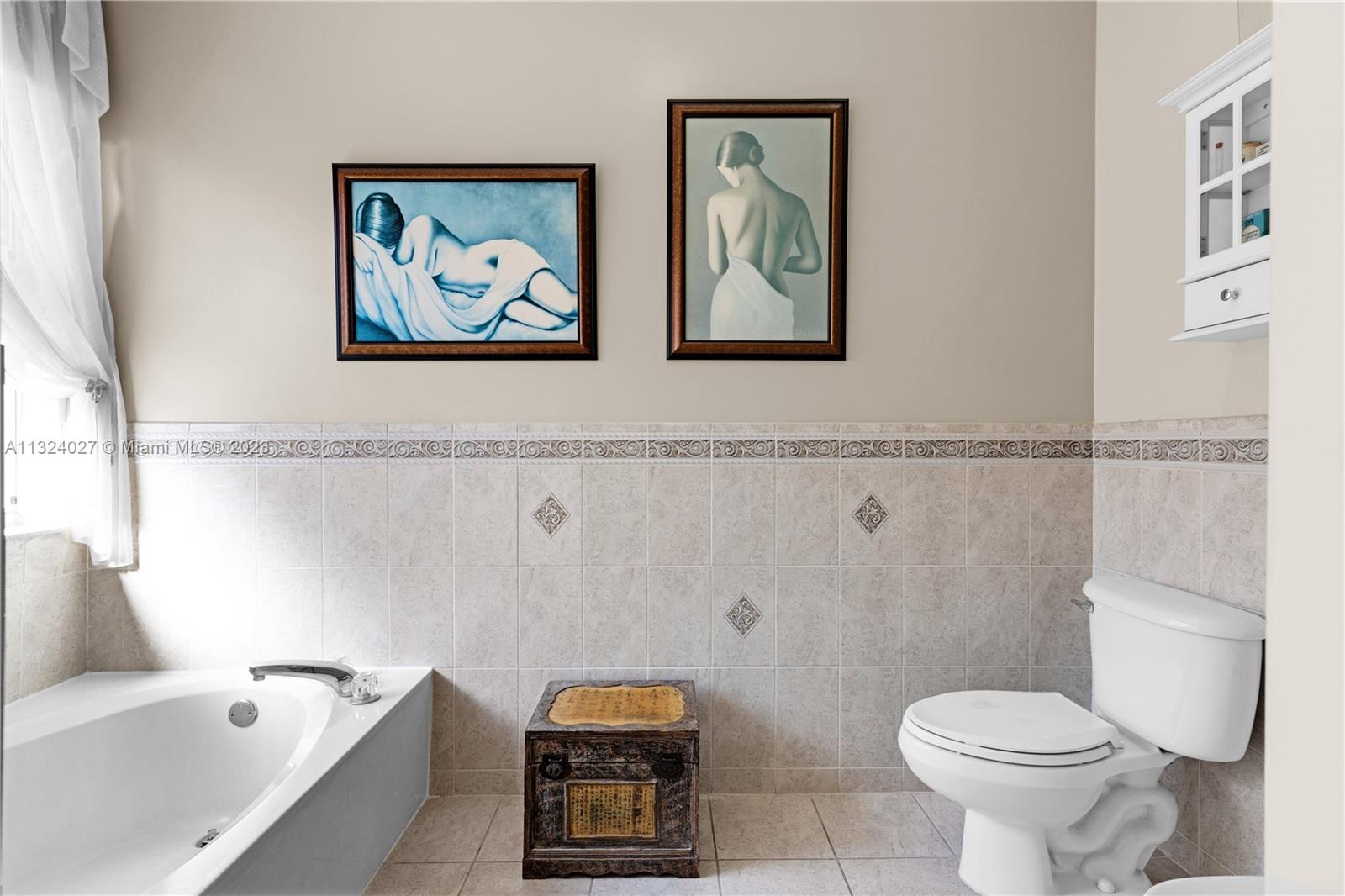 16056 Southwest 66th Terrace Miami, FL 33193 - Photo 12 of 24 a white toilet sitting next to a bathroom sink