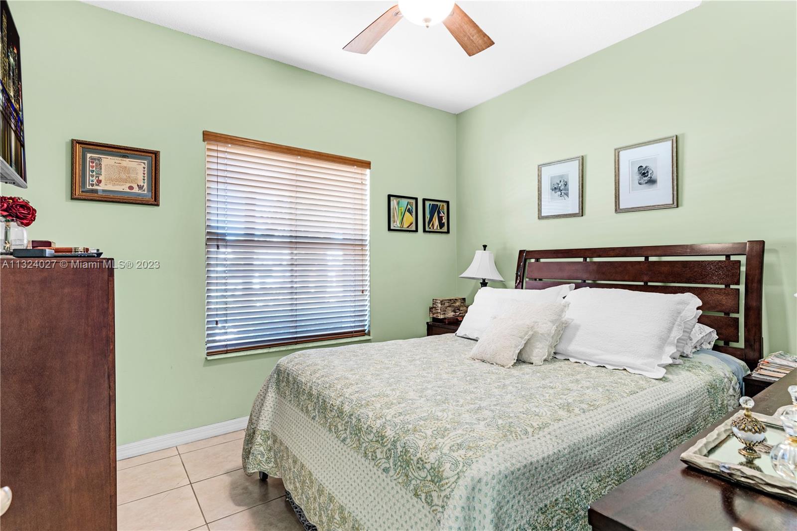 16056 Southwest 66th Terrace Miami, FL 33193 - Photo 14 of 24 a bedroom with a bed and a window