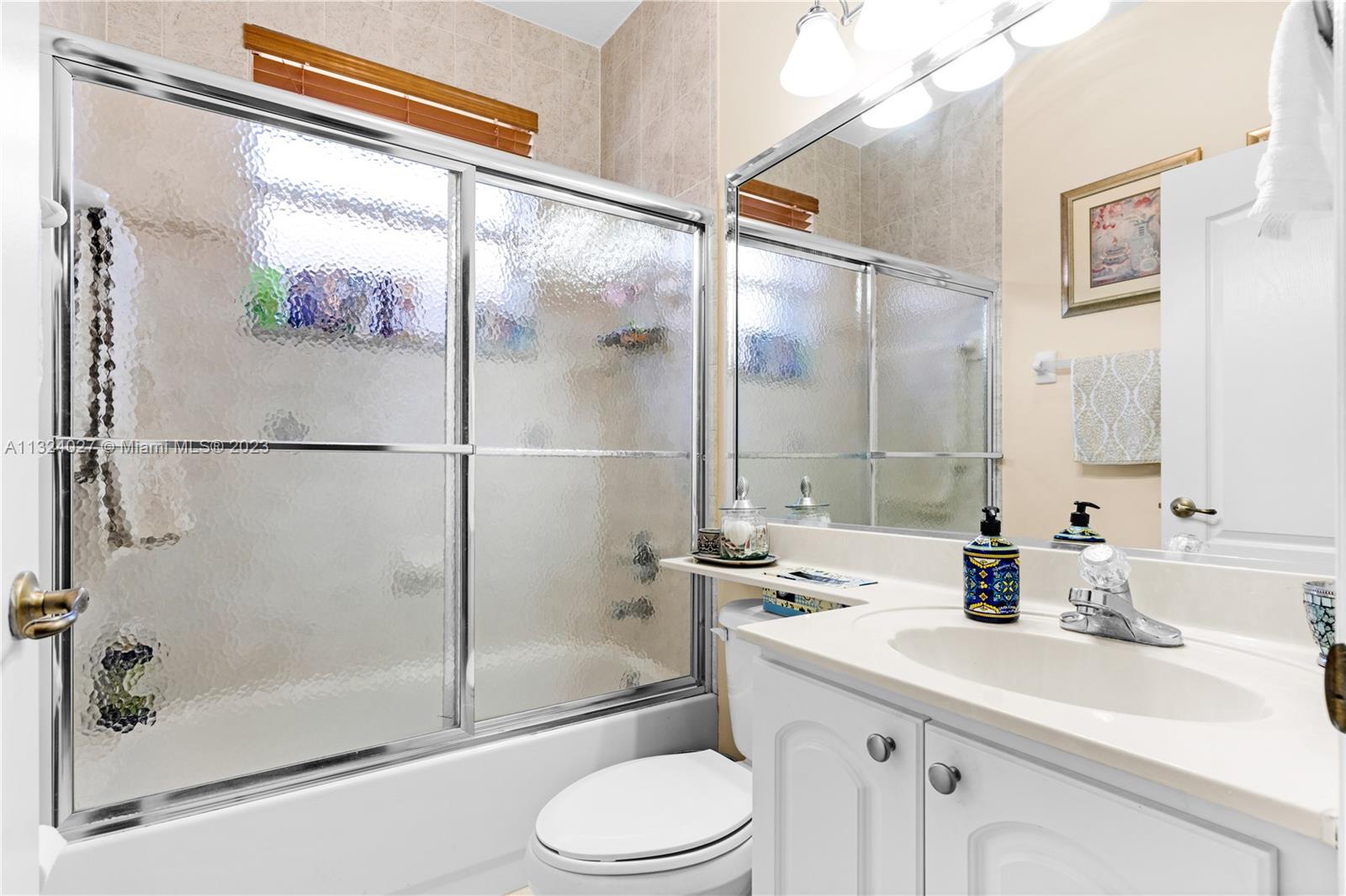 16056 Southwest 66th Terrace Miami, FL 33193 - Photo 15 of 24 a bathroom with a sink toilet and shower