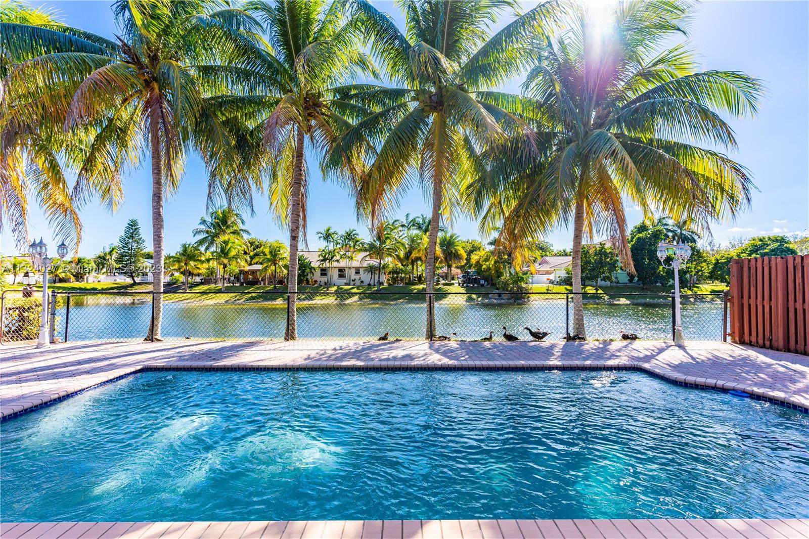 16056 Southwest 66th Terrace Miami, FL 33193 - Photo 18 of 24 a view of swimming pool with a table and chairs