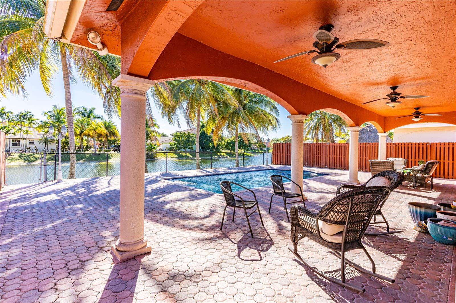 16056 Southwest 66th Terrace Miami, FL 33193 - Photo 19 of 24 a view of a patio with a table and chairs under an umbrella