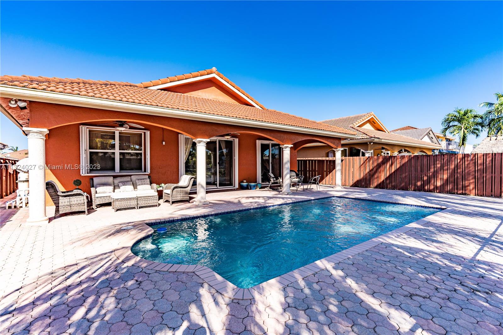 16056 Southwest 66th Terrace Miami, FL 33193 - Photo 22 of 24 a view of a house with swimming pool and sitting area