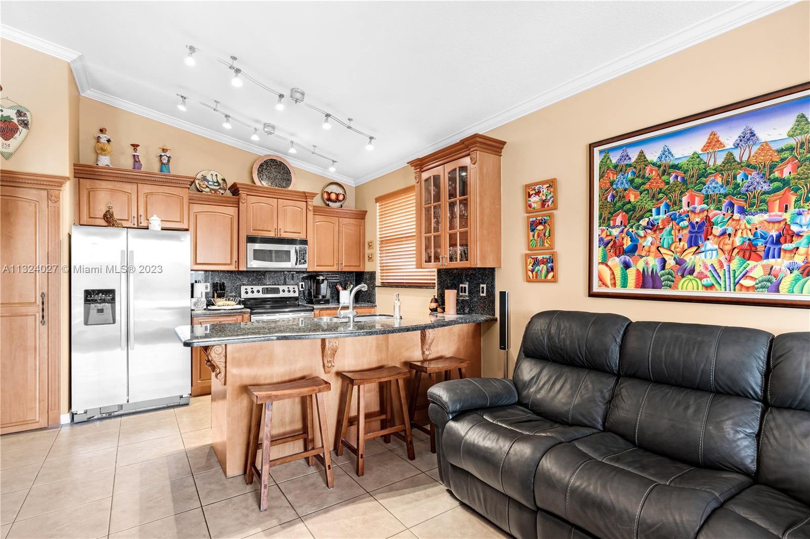 16056 Southwest 66th Terrace Miami, FL 33193 - Photo 8 of 24 a living room with stainless steel appliances furniture and a kitchen view