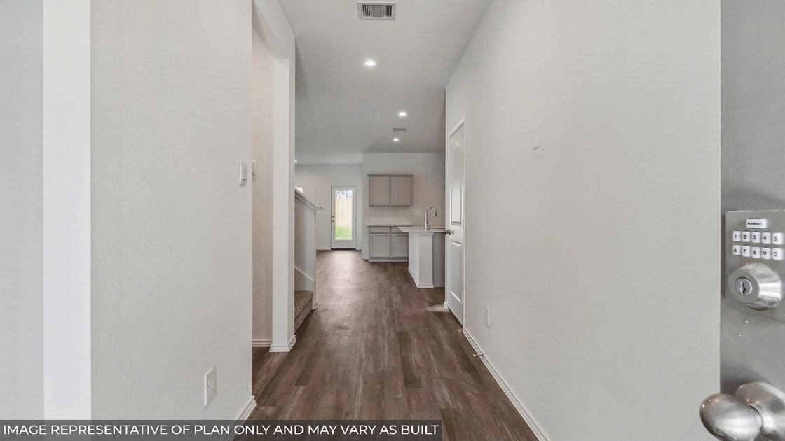 14565 Sunny Pl Drive Splendora, TX 77372 - Photo 3 of 30 a view of a hallway with wooden floor and a bathroom