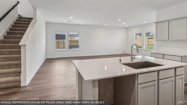 a kitchen with a sink and cabinets