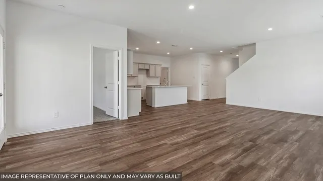 a view of a kitchen with a sink and a refrigerator