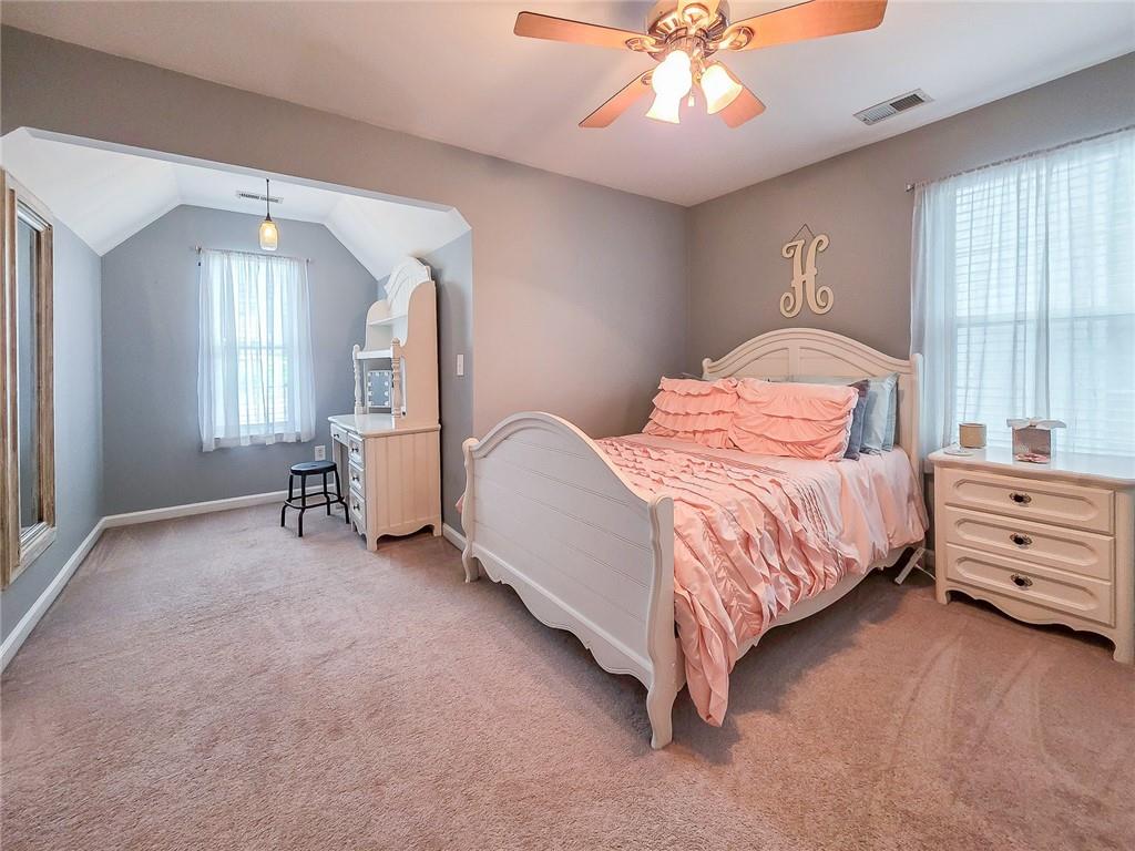 43 Ivy Mist Lane Acworth, GA 30101 - Photo 25 of 58 a bedroom with a bed and a chandelier