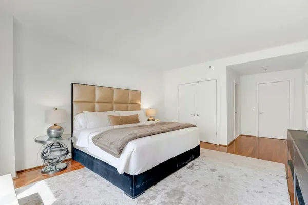 a bedroom with a bed and a mirror