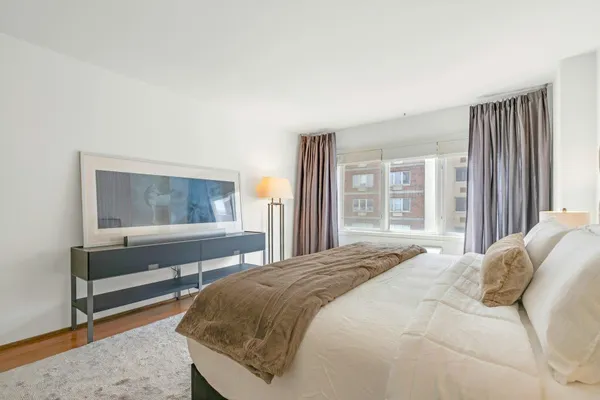 a bedroom with a bed and window