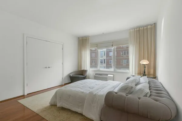 a bedroom with a large bed and a window