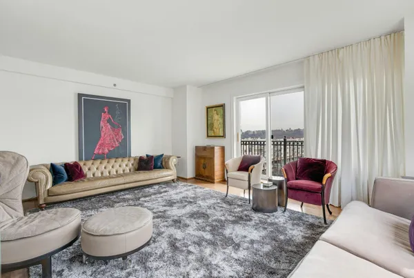 a living room with furniture and a floor to ceiling window