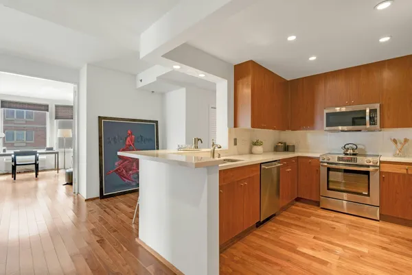 a kitchen with a sink cabinets and wooden floor