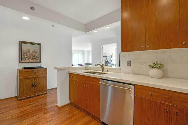 a spacious bathroom with a granite countertop sink and a mirror