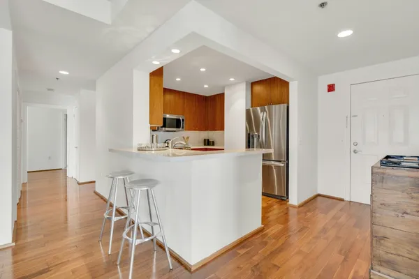 a kitchen with stainless steel appliances a refrigerator and a stove top oven