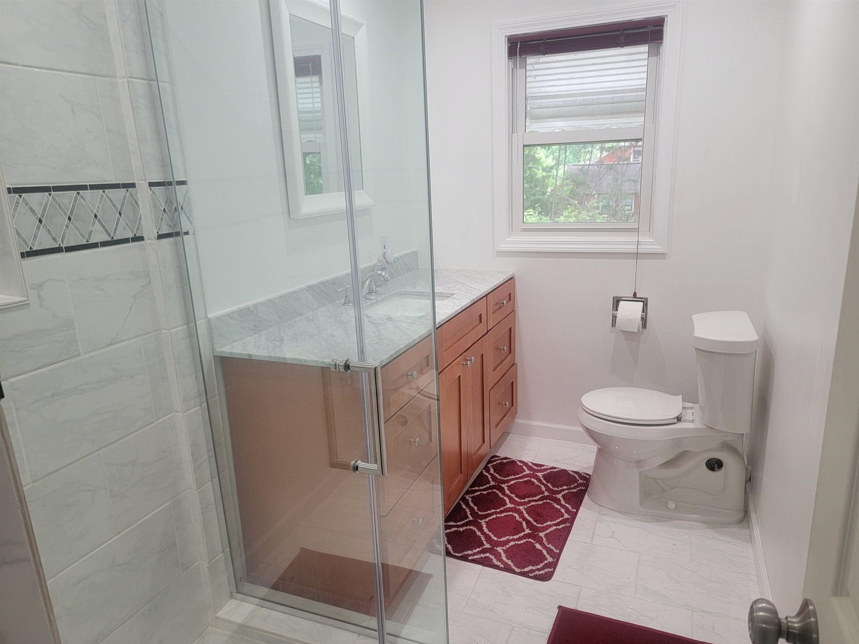3217 Rowena Avenue Durham, NC 27703 - Photo 21 of 30 a bathroom with a toilet and a shower