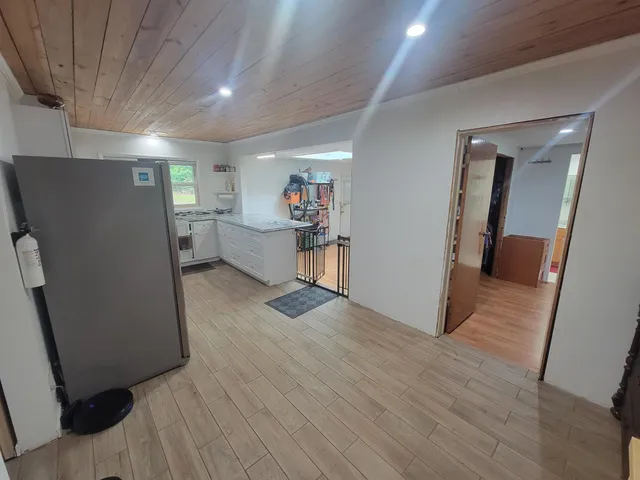 a view of a storage & utility room with closet wooden floor