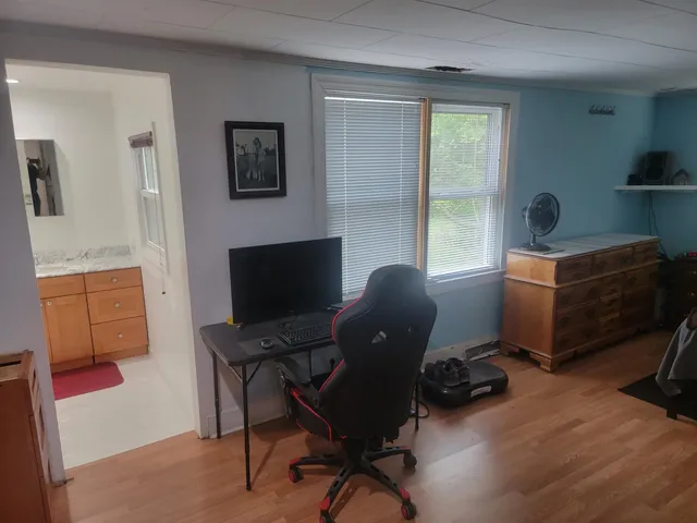 a bathroom with a granite countertop sink a mirror and shower