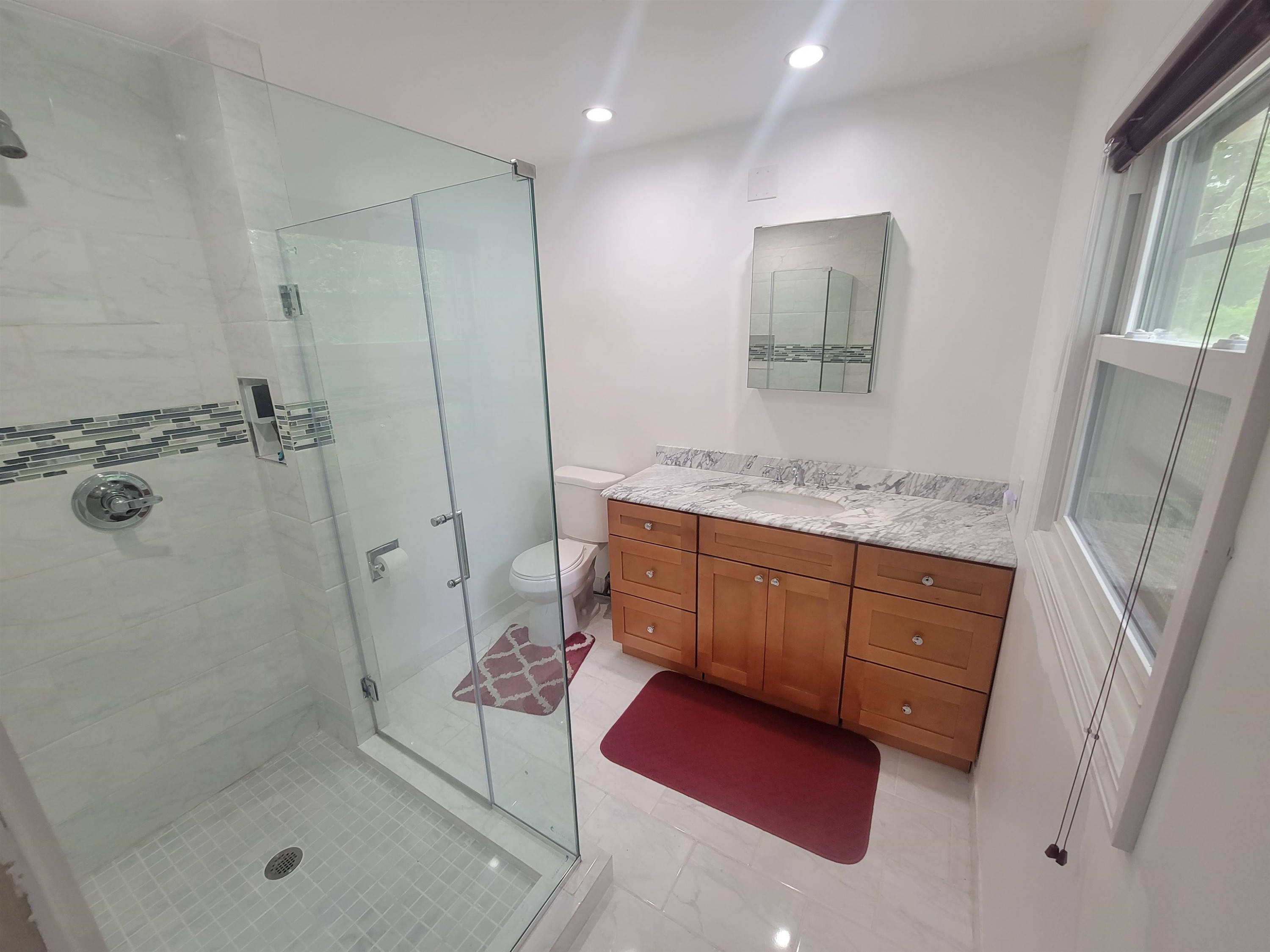 3217 Rowena Avenue Durham, NC 27703 - Photo 26 of 30 a bathroom with a granite countertop sink a mirror and shower